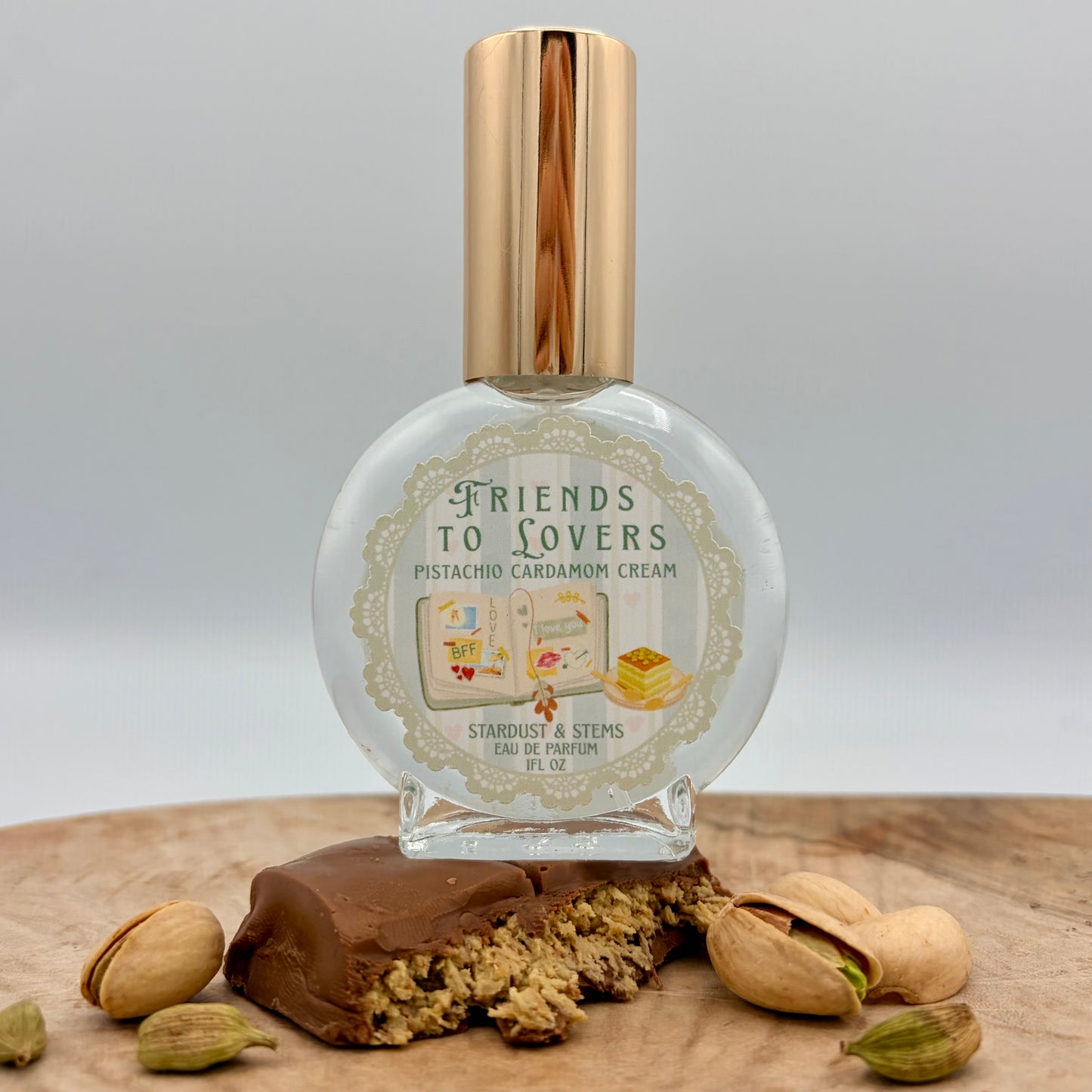 Friends to Lovers Pistachio Cardamom Cream Perfume by Stardust & Stems featuring illustrated open book artwork inspired by the Friends to Lovers romance trope.
