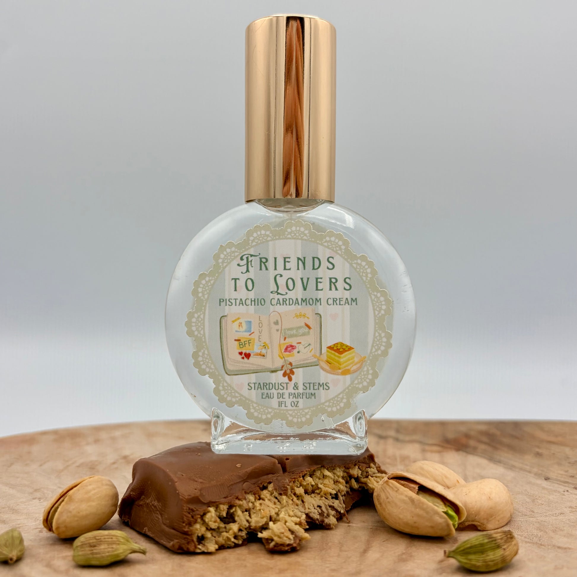 Friends to Lovers Pistachio Cardamom Cream Perfume by Stardust & Stems featuring illustrated open book artwork inspired by the Friends to Lovers romance trope.